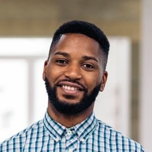 Smiling man in checkered shirt indoors